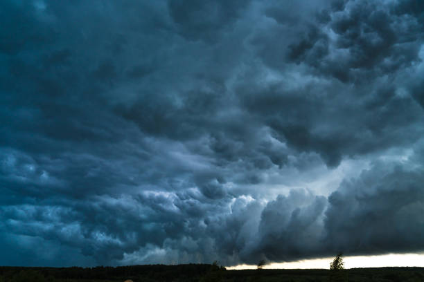 istock Summer landscape with black storm clouds 805479994
