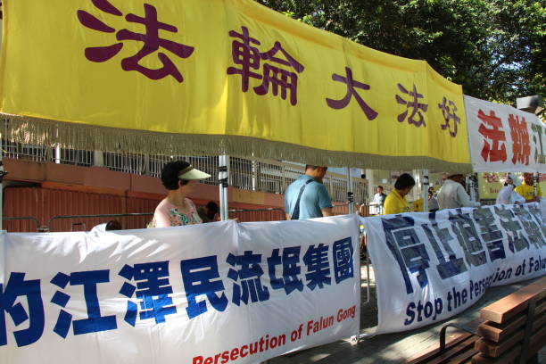 On the second day of President Xi Jinping's visit to Hong Kong, practitioners of Falun hold a demonstration in the heart of the city. The yellow banner states “Falun Dafa is good”. The other banners describe Jiang Zemin’s allegedy “rogue” activities and calls for and end to the alleged persecution of followers of Falun. The demonstrators are also practising Falun’s Qi Gong (Chi Gong) movements on site. xi jinping stock pictures, royalty-free photos & images