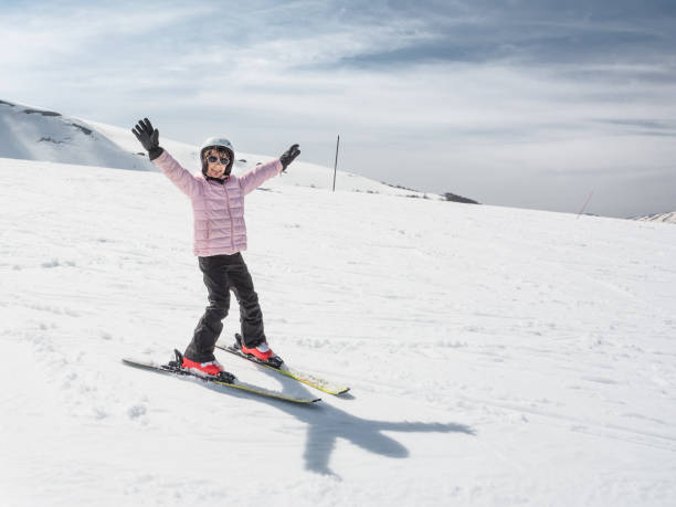 istock Beginner little girl learning to ski 805550376