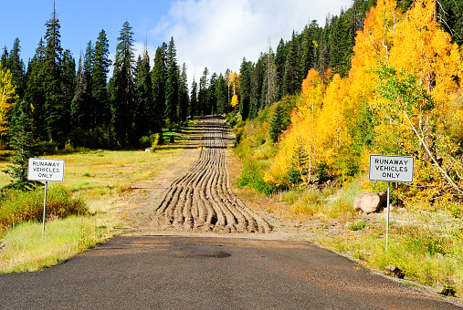 Runaway truck escape route with brightly colored aspens in fall