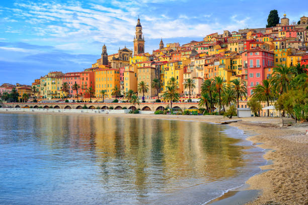 Colorful medieval town Menton on Riviera, Mediterranean sea, France Sand beach beneath the colorful old town Menton on french Riviera, France french riviera photos stock pictures, royalty-free photos & images