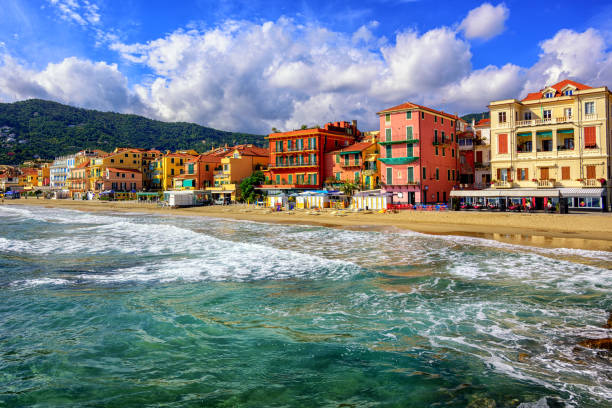 Touristic town Alassio on italian Riviera, Italy Mediterranean sand beach in traditional touristic town Alassio on italian Riviera by San Remo, Liguria, Italy san remo italy photos stock pictures, royalty-free photos & images