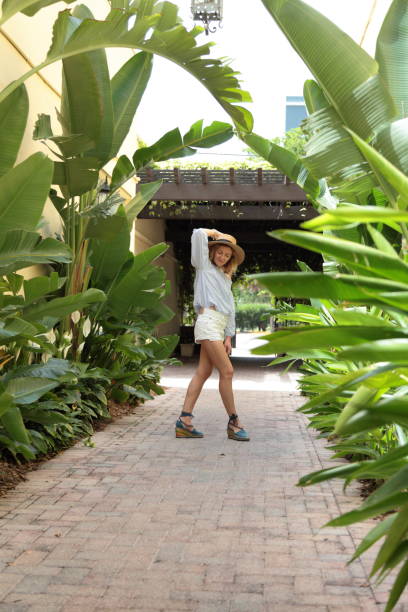 istock Woman is walking down tropical street. 805577934