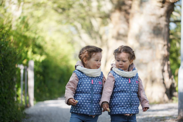 Identical twin girl in a park