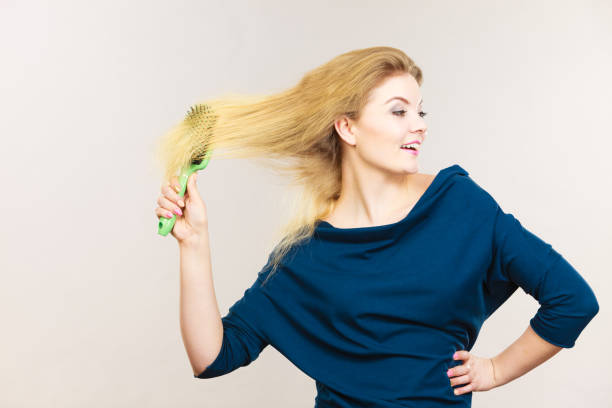 istock Woman brushing her long blonde hair 805660584