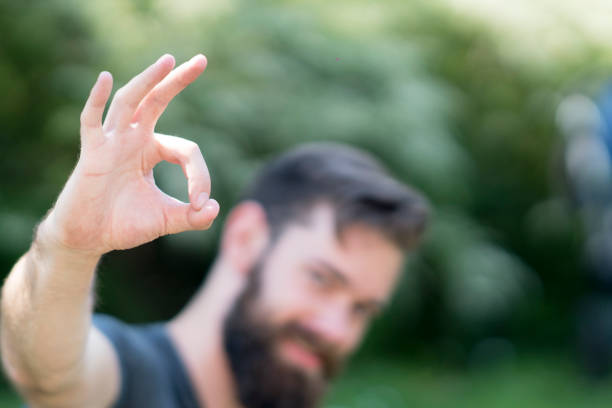 istock Bearded caucasian guy making ok sign at camera. Selective focus on foreground 805666000