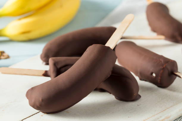 Homemade Frozen Chocolate Covered Bananas Homemade Frozen Chocolate Covered Bananas on a Stick Chocolate Dipped stock pictures, royalty-free photos & images