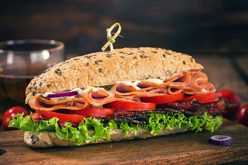 Fresh homemade submarine sandwich with salami,ham and vegetables