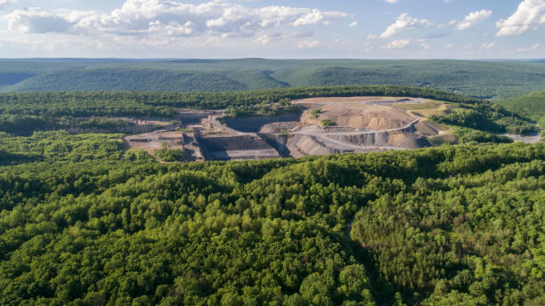 The aerial view to the open-cast mine in Lehigh Valley, Carbon County, Pennsylvania, USA. The aerial view from a drone to the open-cast mine in Lehigh Valley, Carbon County, Pennsylvania, USA. The sunny summer day. carbon county utah stock pictures, royalty-free photos & images