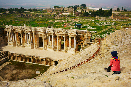 A traveler sits at the Ephesus Theater, Turkey