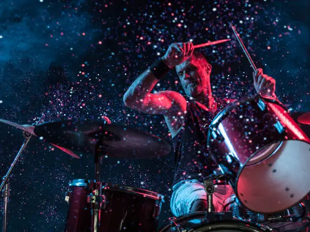 Photo of Rock N Roll Drummer Sparkles In The Air