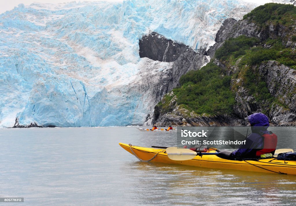 Single and double kayaks in Blackstone Bay, near glacier, Alaska single and double kayaks near face of glacier during rainstorm, Blackstone Bay, Alaska Alaska - US State Stock Photo