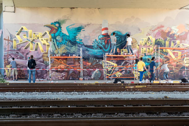 Graffiti Artist at Meeting of Styles, Wiesbaden, painting a huge graffito. Meeting of Styles is an annual series of worldwide graffiti and Hip Hop events. International Graffiti Artists are invited to paint over 3000 squaremeters of concrete walls in public space at the so called Brueckenkopf in Mainz-Kastel.