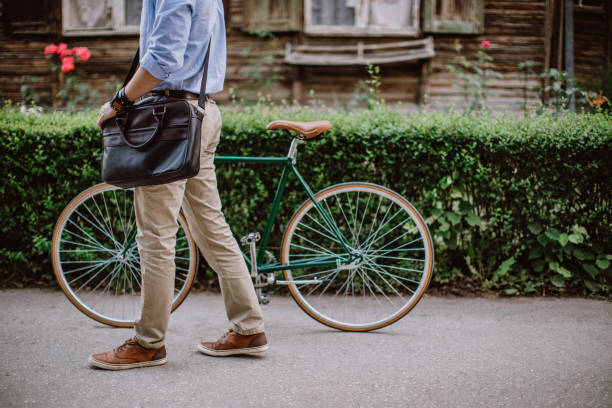 Green way to get to office Handsome young businessman with bicycle in the city urbane stock pictures, royalty-free photos & images