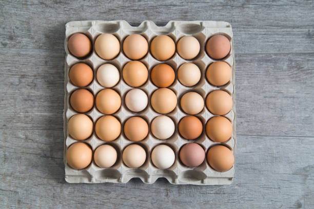 istock Crate of eggs on a wooden background 805873638