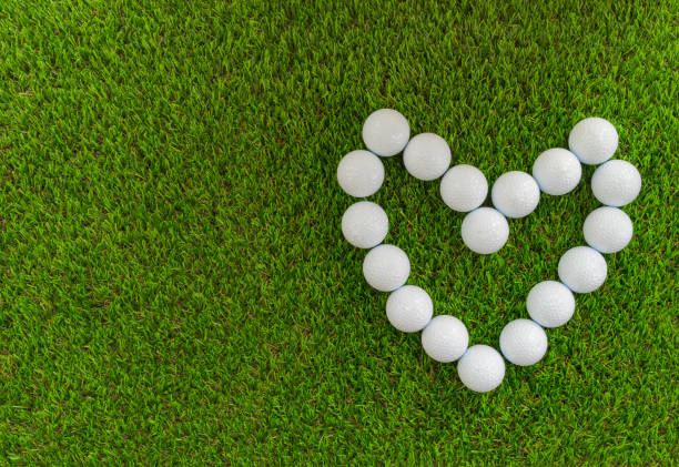 Golf concept : Golf balls arranged as heart symbol. stock photo