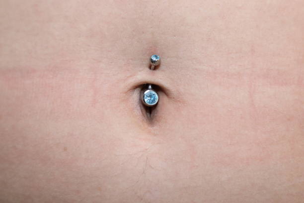 istock woman with navel piercing 806040504