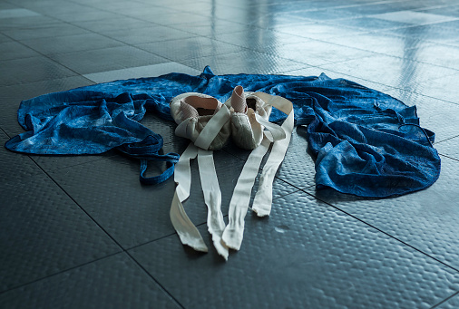 A ballet dancer's ballet pointe shoes and her practice wrap skirt
