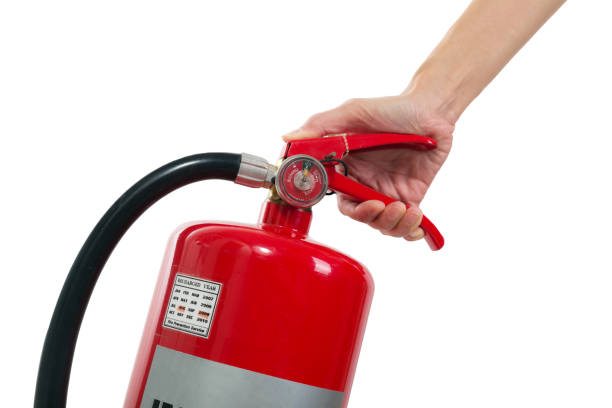 istock Hand holding fire extinguisher isolated white background. 806047226
