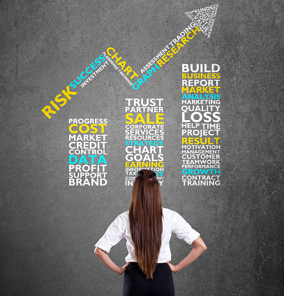 Businesswoman looking on blackboard