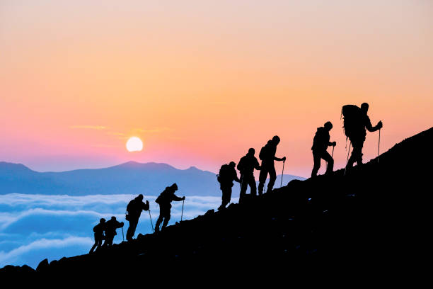 istock Silhouettes of hikers At Sunset 806081534
