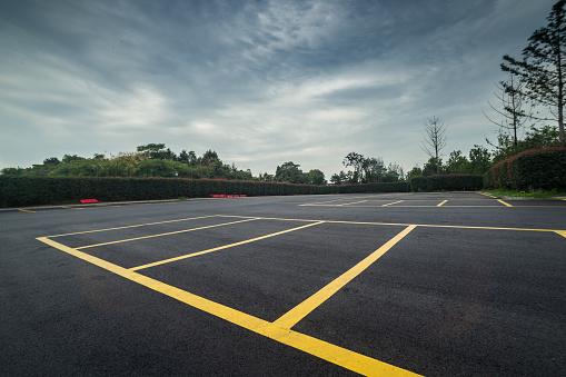 wet parking lot with black asphalt after rain