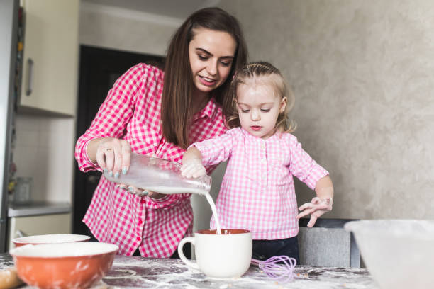 istock Mom and daughter together in the kitchen 806097044