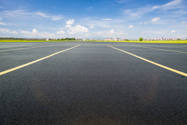 istock parking lot with black asphalt under blue sky 806097090