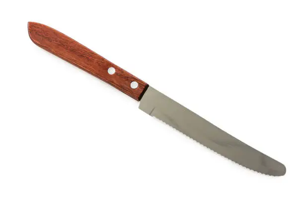 serrated knife for cutting bread on white in top view