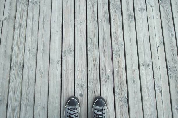 istock Gray sneakers on wooden background with copy space 806116456