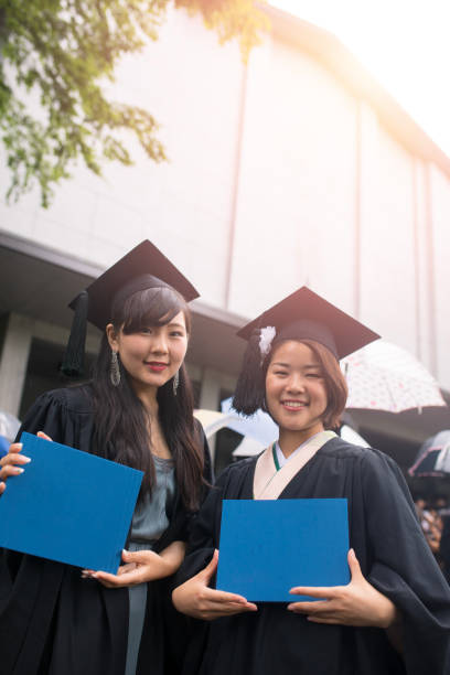 istock Happy graduates holding diplomas 806116668
