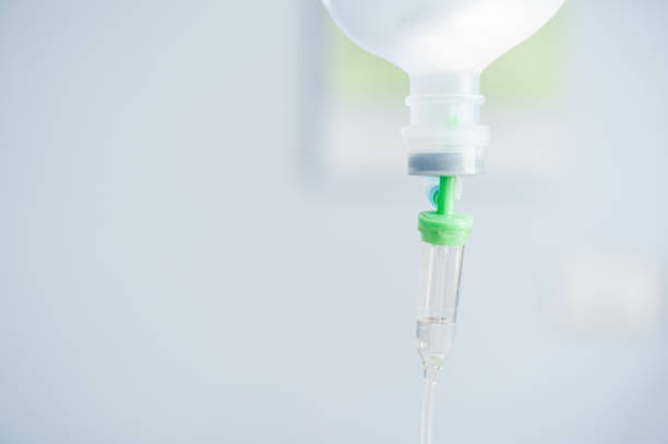istock Close up saline solution drip for patient and infusion pump in hospital 806131590