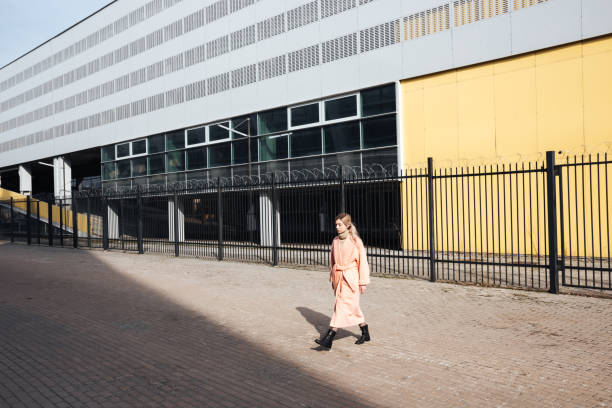 istock Serious young blonde lady walking outdoors. Looking aside. 806145130