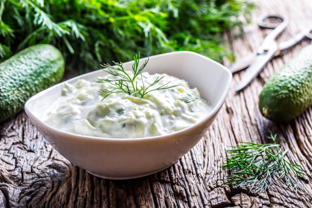 Tzatziki. Traditional greek dip sauce or dressing tzatziki prepared  with grated cucumber sour cream yogurt olive oil and fresh dill. Mediterrannan cuisine Tzatziki. Traditional greek dip sauce or dressing tzatziki prepared  with grated cucumber sour cream yogurt olive oil and fresh dill. Mediterranean cuisine. tzatziki stock pictures, royalty-free photos & images