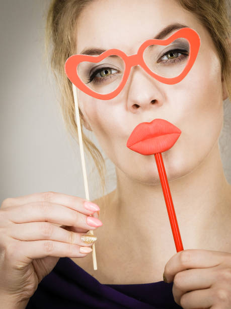 istock woman holds carnival accessories on stick 806152410