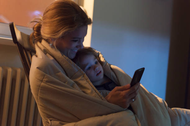 istock Mother and son looking at mobile phone 806160542