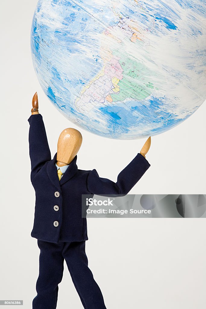 Artists dummy lifting globe  Above Stock Photo
