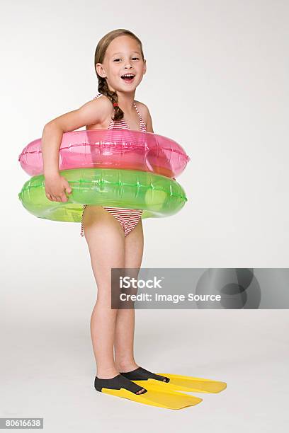 A Girl Wearing Colchonetas Inflables Anillos Foto de stock y más banco de imágenes de Flotador - Inflable - Flotador - Inflable, Fondo blanco, Niño