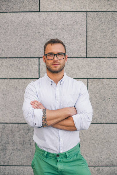 istock Cool young bearded hipster man wearing shirt, keeping arms crossed 806199468