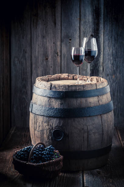 istock Tasty red wine and grapes and oak barrel 806202238