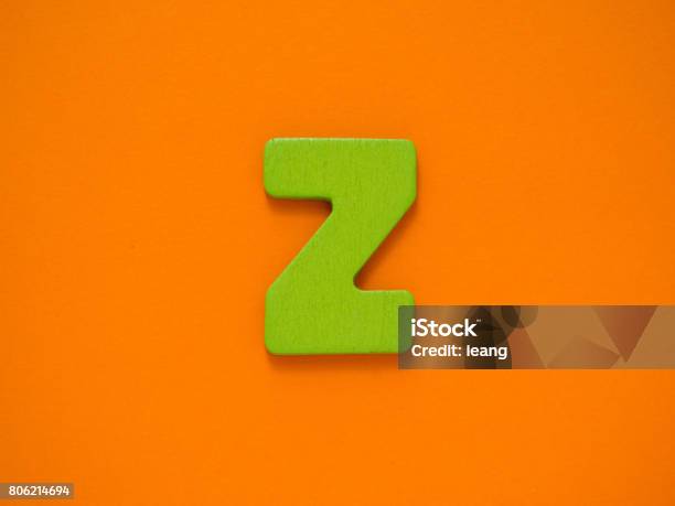 Capital Letter Z Green Letter Z From Wood On Orange Background Stock Photo - Download Image Now