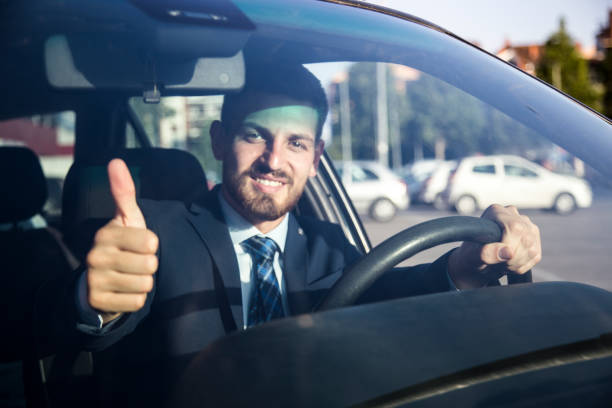 istock Mid Age successful businessman driving a car 806221030