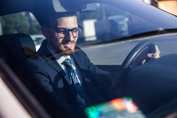 istock Mid Age successful businessman driving a car 806221152