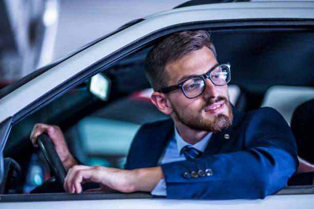 istock Mid Age successful businessman driving a car 806224002