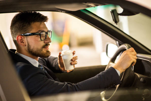 istock Mid Age successful businessman driving a car 806224196