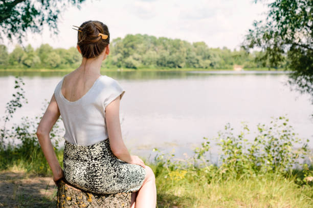 istock Woman Sitting Close to the River 806232078