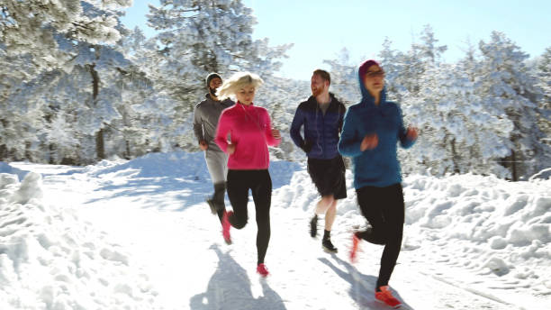 istock Sportspeople running in nature on snowy path 806246882
