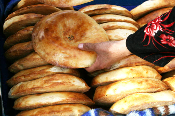 istock Uzbek national bread. Traditional eastern white flat bread baked in old stove. 806287112