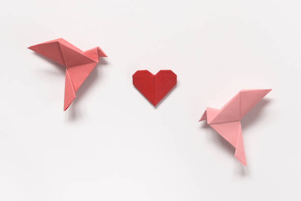 Pink Birds and Red Heart of origami on white background. Gift card for Valentine's Day. stock photo
