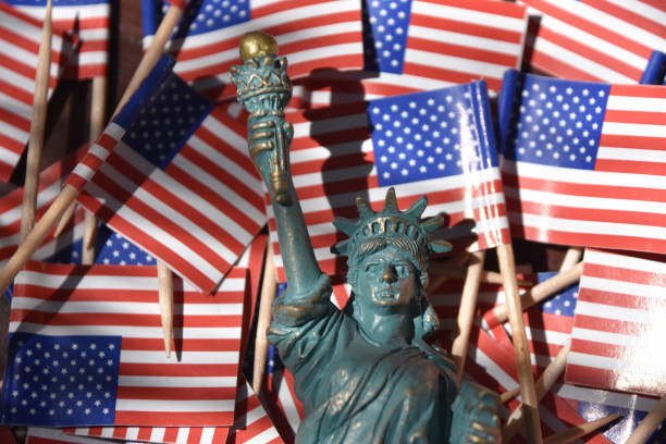 istock Statue of Liberty against the backdrop of US flags 806295768